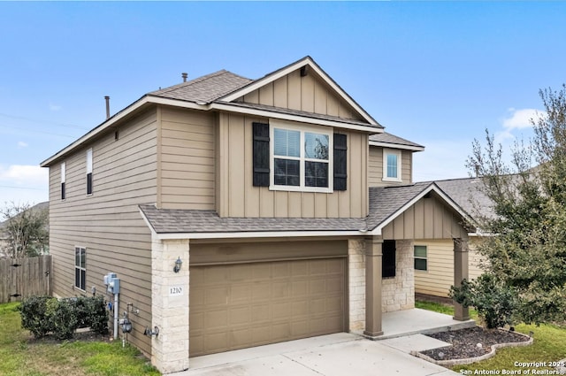 view of front of property with a garage, a shingled roof, concrete driveway, fence, and board and batten siding