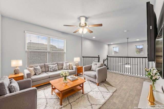 living room with plenty of natural light, a ceiling fan, and recessed lighting