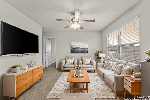 living area featuring ceiling fan and light wood finished floors