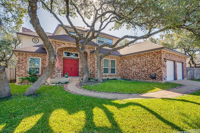 view of front of home featuring brick siding, fence, and a front lawn