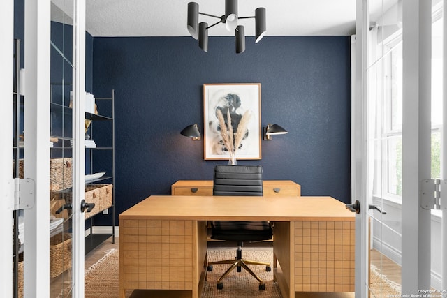 office space with a textured wall and french doors