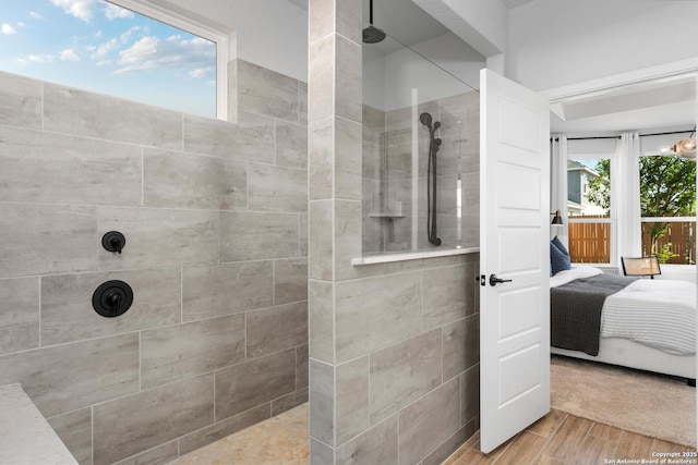 full bathroom featuring wood finished floors, walk in shower, and connected bathroom