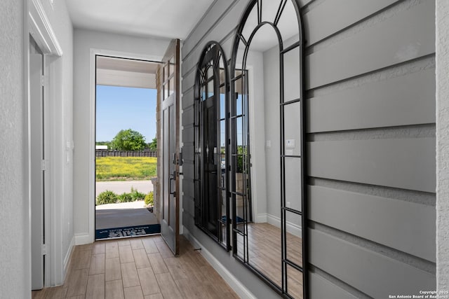 entrance foyer featuring baseboards and wood finished floors