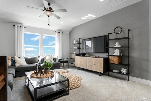 living room featuring light carpet, baseboards, visible vents, lofted ceiling, and ceiling fan