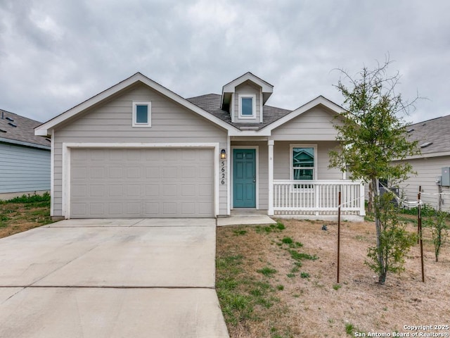 view of front of property with a garage, a shingled roof, a porch, and concrete driveway