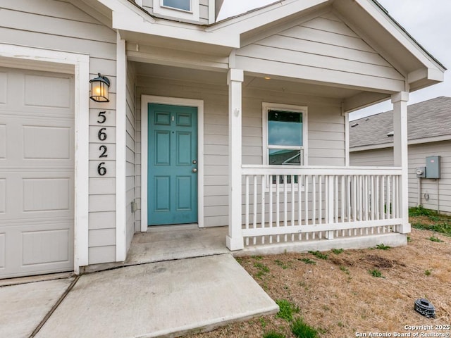 doorway to property featuring a garage and covered porch