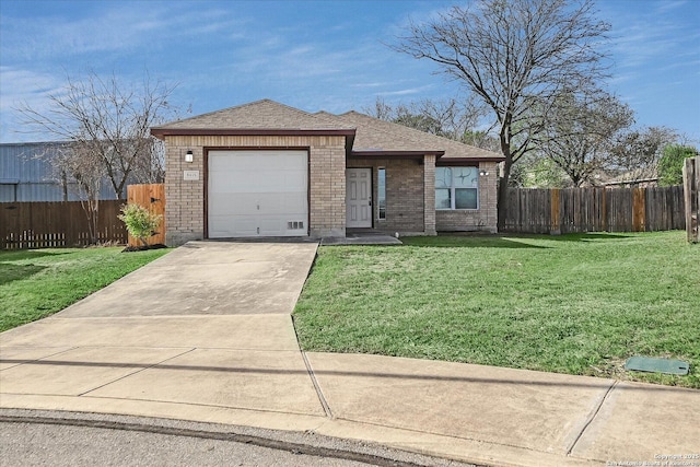 view of front facade with a garage, fence, a front lawn, and concrete driveway