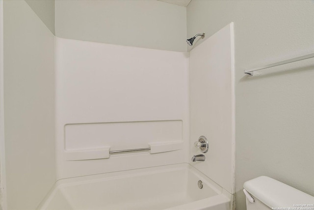 bathroom featuring toilet and bathing tub / shower combination