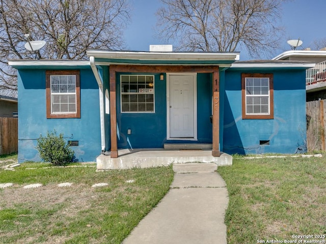 bungalow-style house featuring crawl space, fence, and stucco siding