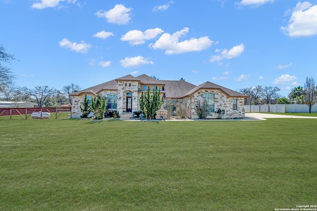 french country style house with fence and a front lawn