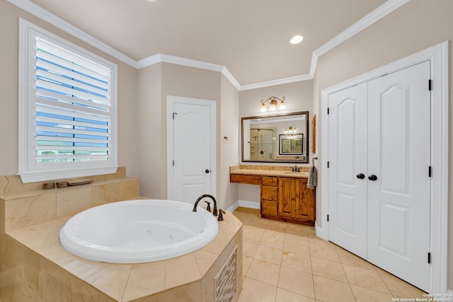 bathroom featuring a tub with jets, ornamental molding, vanity, and tile patterned floors