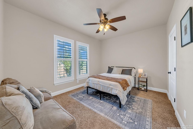 carpeted bedroom featuring baseboards and a ceiling fan