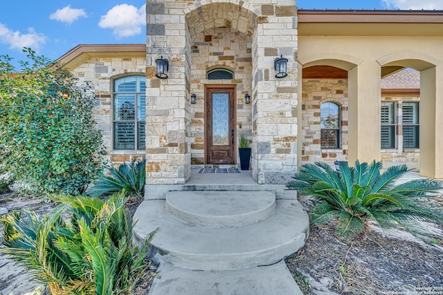 view of exterior entry featuring stone siding