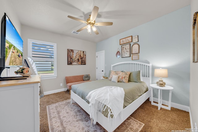 bedroom featuring ceiling fan, light colored carpet, visible vents, and baseboards