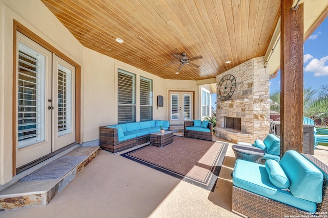 view of patio featuring a ceiling fan, french doors, and an outdoor living space with a fireplace