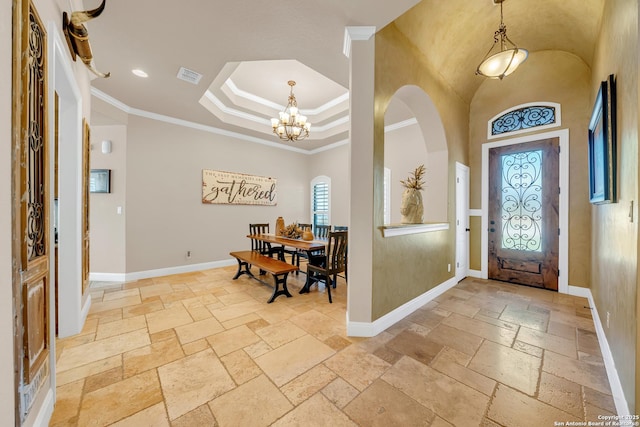 entryway featuring baseboards, visible vents, ornamental molding, stone tile flooring, and a chandelier