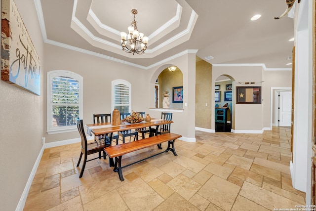 dining area with baseboards, an inviting chandelier, a raised ceiling, stone tile flooring, and crown molding