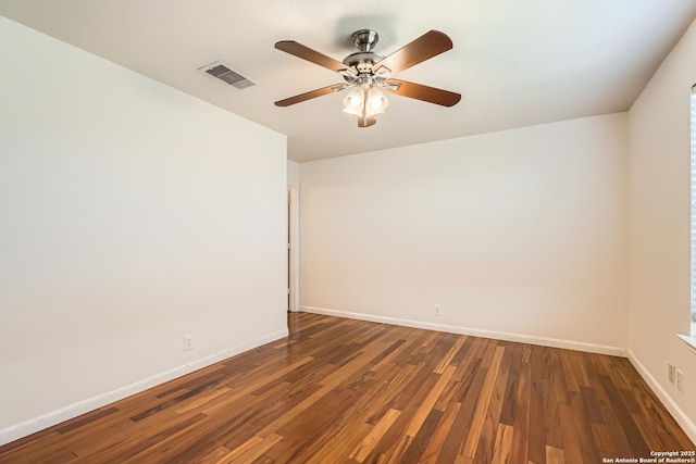 unfurnished room featuring ceiling fan, wood finished floors, visible vents, and baseboards