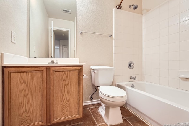 full bathroom featuring toilet, bathing tub / shower combination, vanity, visible vents, and tile patterned floors