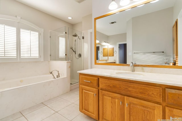 bathroom with a shower stall, vanity, visible vents, and tile patterned floors