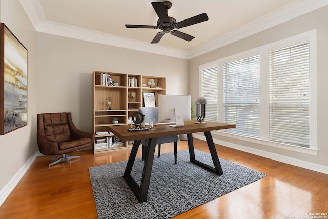 office featuring baseboards, wood finished floors, a ceiling fan, and crown molding