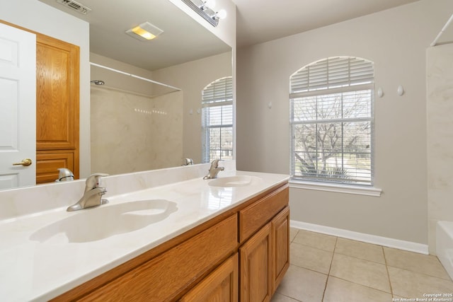 full bath featuring a bath, visible vents, a sink, and tile patterned floors