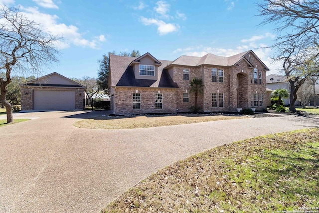 view of front of house with a garage and brick siding