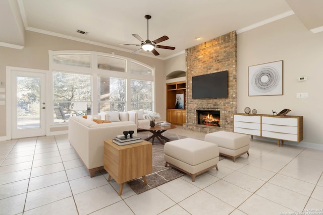 living room with a fireplace, light tile patterned floors, visible vents, ornamental molding, and ceiling fan