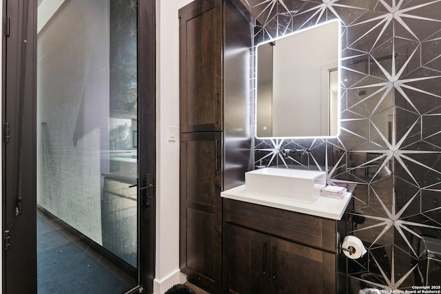 bathroom with backsplash, tile walls, and vanity