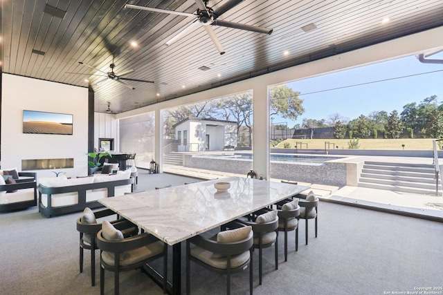 view of patio with outdoor dining space, a ceiling fan, an outdoor living space, and a fenced in pool