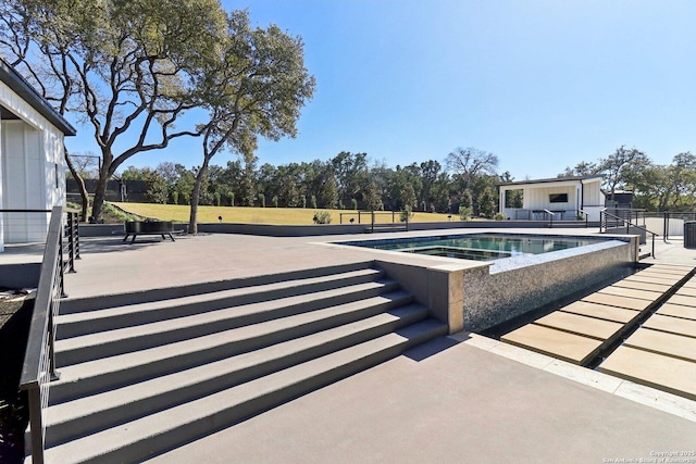 view of swimming pool with a fenced in pool and a patio area