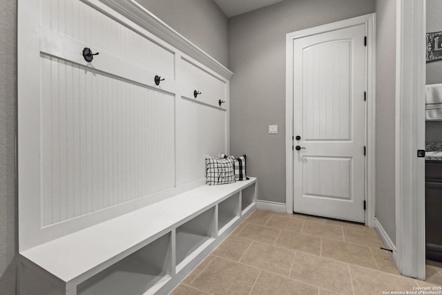 mudroom featuring light tile patterned flooring and baseboards