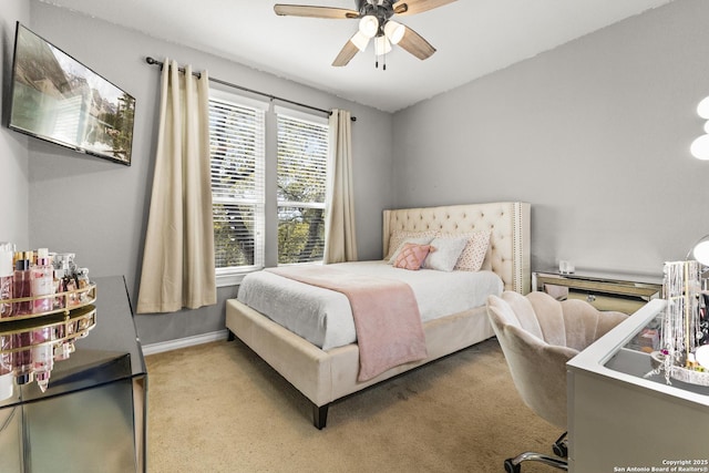 carpeted bedroom with a ceiling fan and baseboards