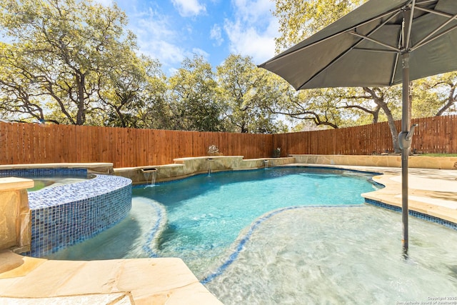 view of swimming pool with a pool with connected hot tub and a fenced backyard