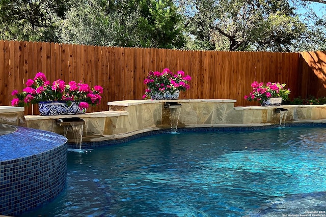 view of swimming pool featuring a fenced in pool, fence, and central air condition unit