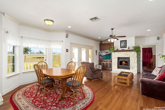 dining room with crown molding, visible vents, and wood finished floors