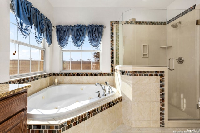 bathroom with a tub with jets, a stall shower, and vanity