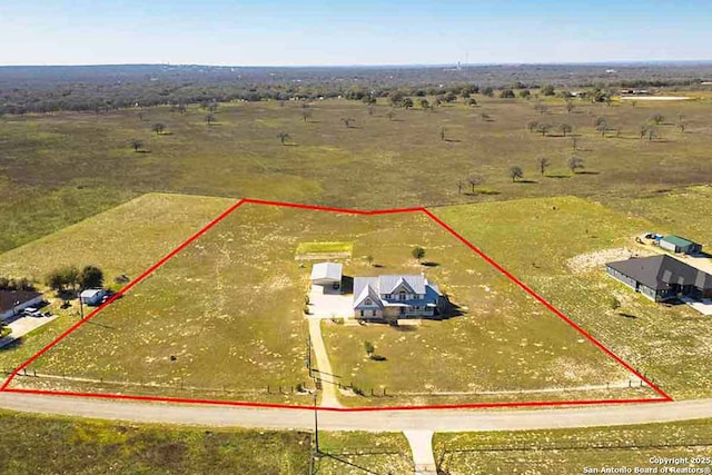 birds eye view of property with a rural view