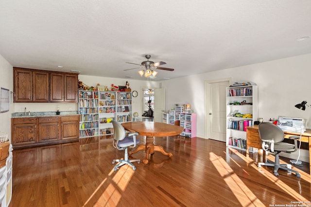 dining space featuring ceiling fan and dark wood-style flooring