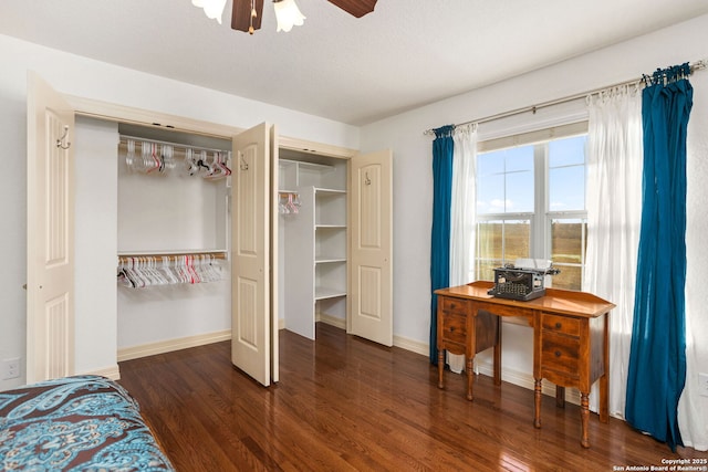 bedroom featuring a closet, baseboards, and wood finished floors