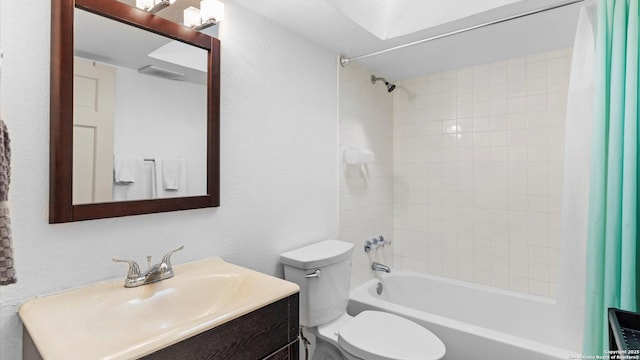 bathroom featuring visible vents, a textured wall, toilet, shower / bath combo with shower curtain, and vanity