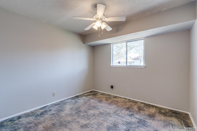 carpeted empty room with ceiling fan, a textured ceiling, and baseboards