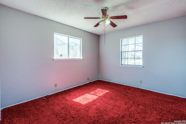 carpeted spare room with a ceiling fan and a textured ceiling