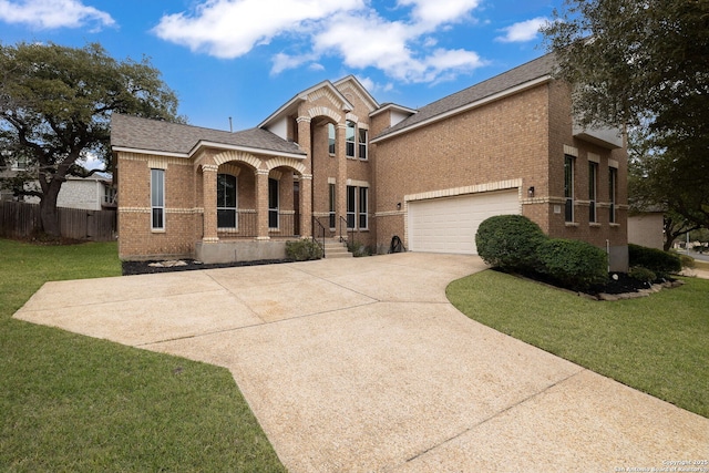 view of front of home featuring a garage, a front lawn, concrete driveway, and brick siding