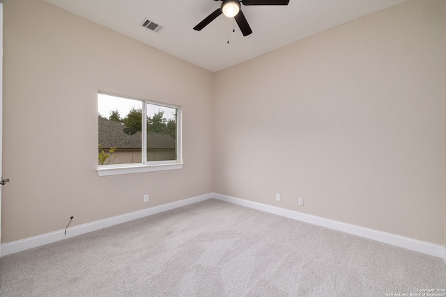 spare room with ceiling fan, carpet floors, visible vents, and baseboards