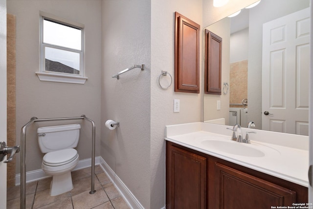 bathroom featuring baseboards, vanity, toilet, and tile patterned floors