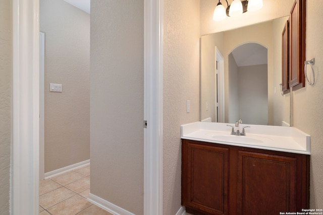 bathroom featuring vanity, baseboards, and tile patterned floors