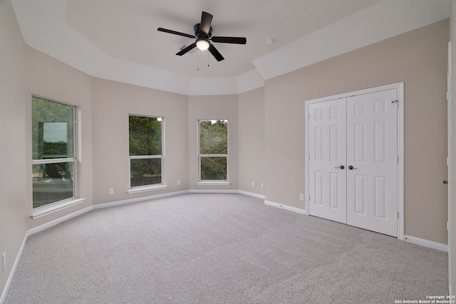 unfurnished bedroom with carpet, ceiling fan, and baseboards