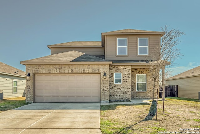 traditional-style home with a garage, driveway, and brick siding