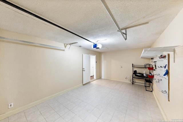 garage with baseboards and a garage door opener